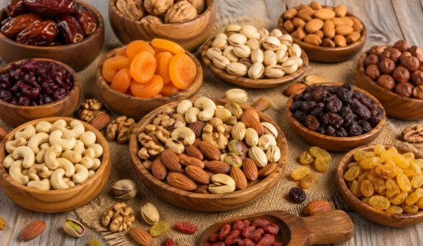 Fresh assorted healthy nuts and dried fruits arranged in a wooden bowl for daily nutrition
